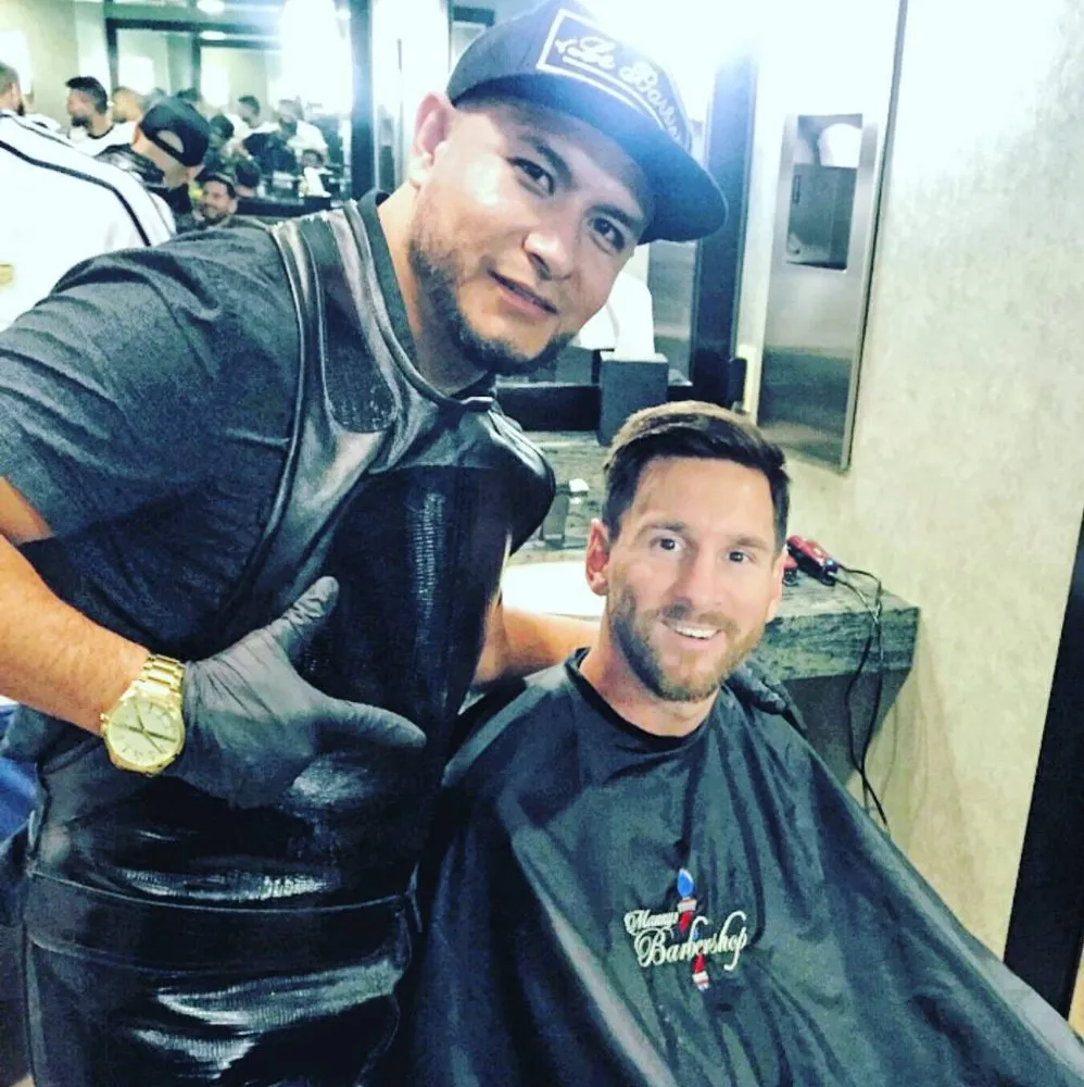 Manny with Lionel Messi in the barber chair